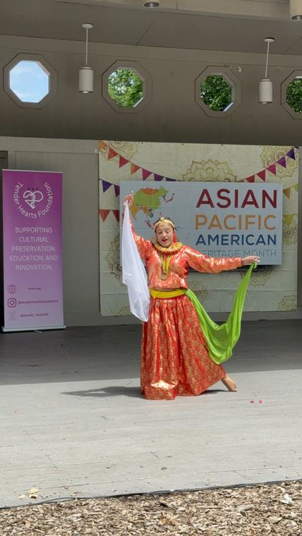 Performers in traditional dress on stage at the AAPI Cultural Festival.