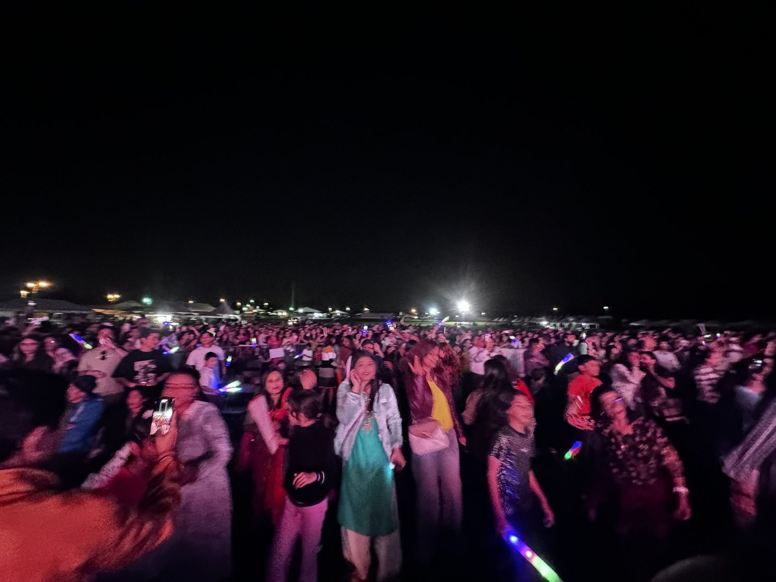 An enormous crowd packed in front of the festival stage after dark.